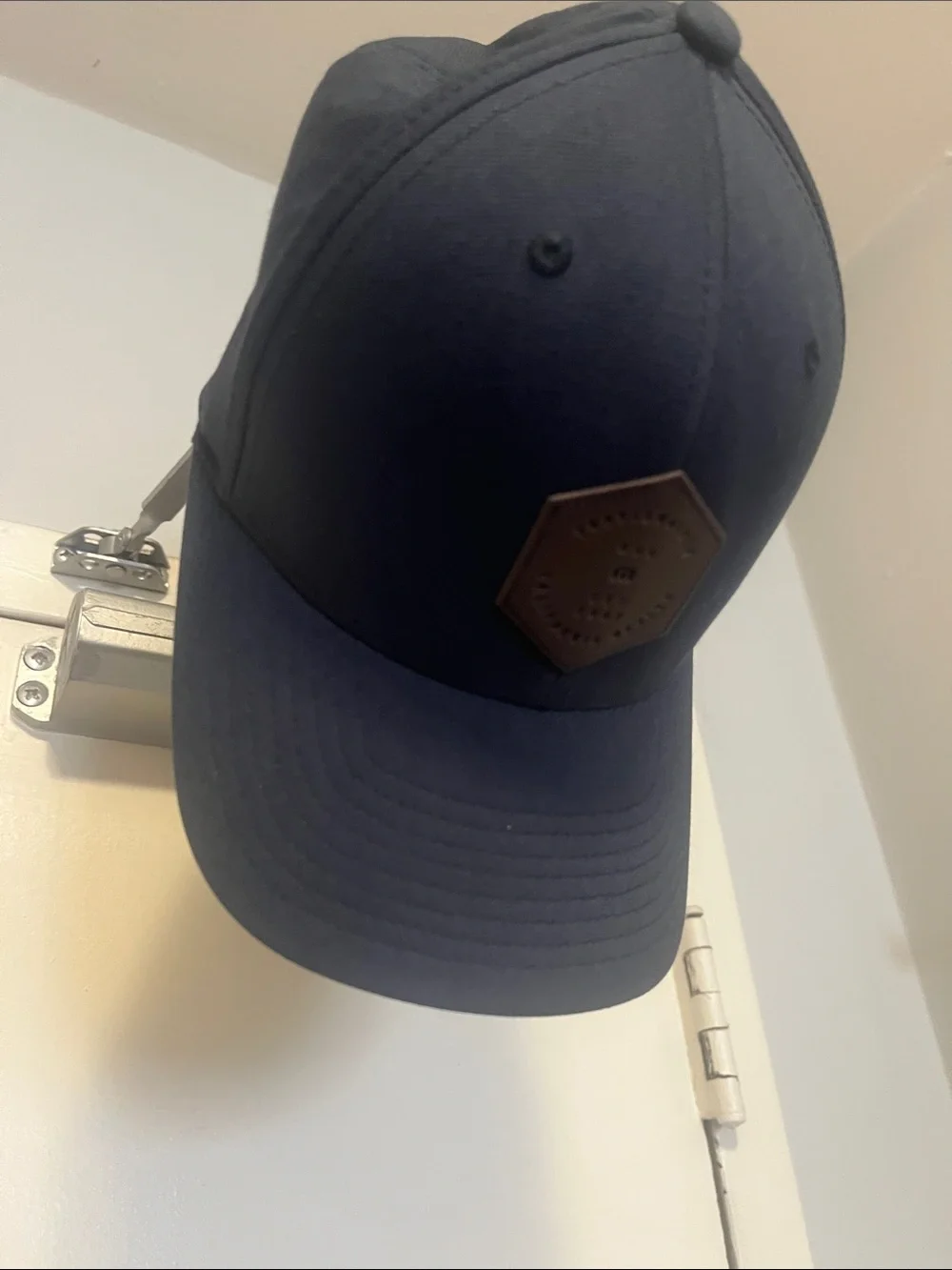 Travis Mathew Navy Blue Baseball Cap with Brown Hex Patch